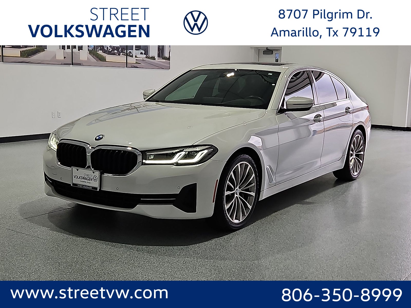 2023 BMW 530 i xDrive in White Metallic — front three-quarter view